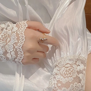 Elegant gold double-layer star ring with sparkling zircons on a white lace background