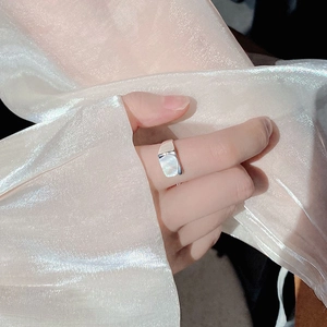 Detail of adjustable S925 silver ring featuring a rectangular white shell inlay on model