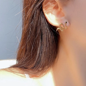 Elegant gold snake-shaped S925 sterling silver stud earring worn on model's ear