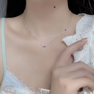 Close-up of S925 sterling silver necklace with three colorful round zirconia on a model
