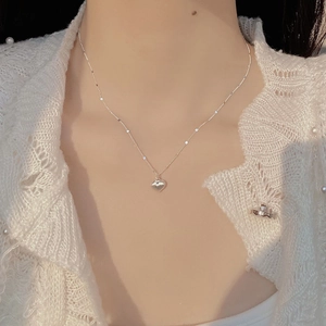 Minimalist S925 sterling silver heart necklace with glossy finish on elegant model