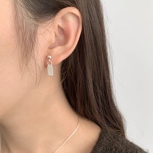 Detail view of S925 sterling silver tassel drop earrings with beads on a model