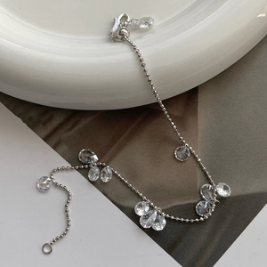 Close-up of S925 sterling silver chain with pear-cut cubic zirconia on a white plate
