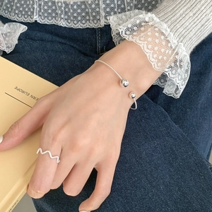 Detailed view of S925 silver twist cuff bracelet with silver beads and wave ring set