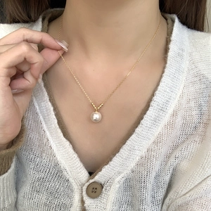 Elegant gold S925 silver necklace with a large round white pearl pendant on model