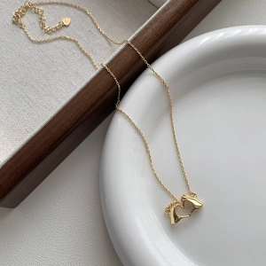 Detail of S925 sterling silver heart hands pendant with adjustable gold plated chain