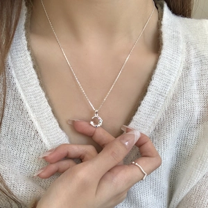 925 silver moon necklace with colorful crystals and wave ring on a white knit sweater