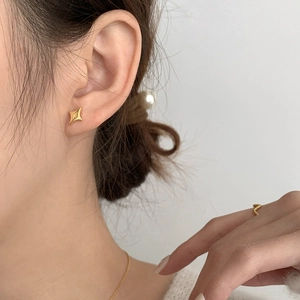 Minimalist S925 sterling silver gold plated star stud earrings worn by a model