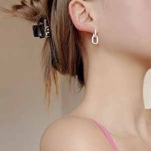 Minimalist S925 sterling silver knot earrings for women shown as worn by a model