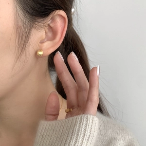 Minimalist S925 sterling silver frosted gold bean stud earrings on a female model