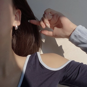 Minimalist square geometric silver earring shown on a model for a modern commute look