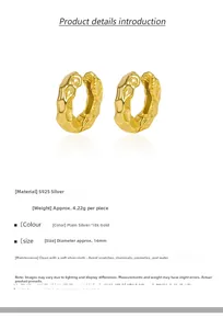 Detailed view of 14mm S925 sterling silver hoop earrings with hammered gold texture