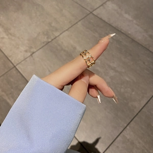 Minimalist gold S925 silver ring featuring hollow B-letter pattern on model index finger