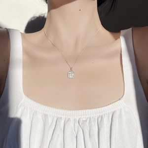 Detailed view of S925 silver necklace with white shell butterfly pendant on woman neck