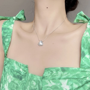S925 sterling silver shell pendant necklace with delicate ribbed texture on a model