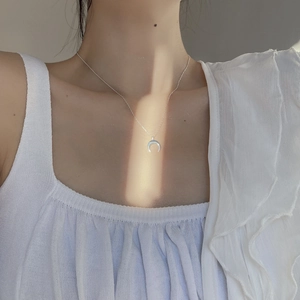 Minimalist S925 sterling silver crescent moon pendant necklace worn on model neck