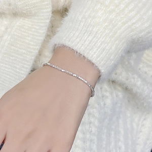 Detailed view of S925 sterling silver faceted slice bracelet on a model wrist