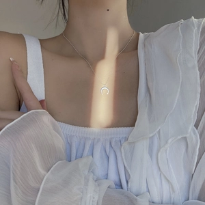 Elegant S925 sterling silver crescent moon pendant necklace worn on a model's neck