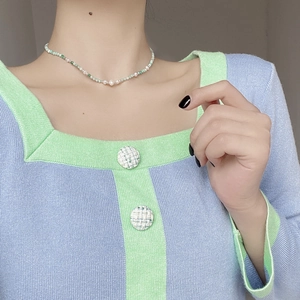 Close-up of S925 silver necklace with baroque pearls and green amazonite on a model