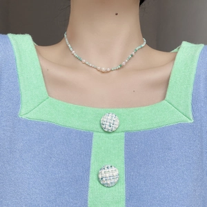Close-up of S925 silver beaded necklace with Amazonite and pearls on model neck
