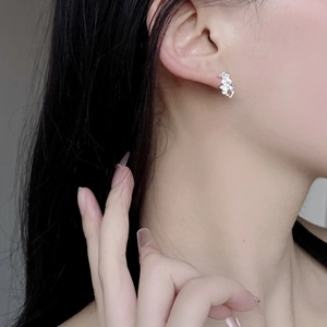 Close-up of irregular S925 sterling silver stud earrings with sparkling pavé stones