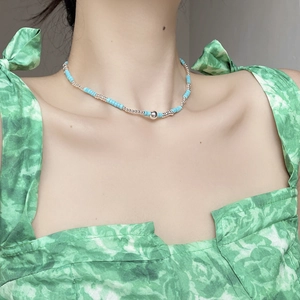 Detail of S925 silver turquoise beaded necklace on neck showing blue disc beads