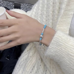 Detail of S925 sterling silver beaded bracelet with turquoise stones on model wrist