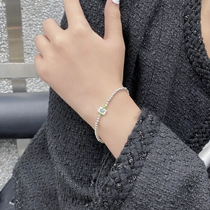 S925 sterling silver Mahjong bracelet with beaded chain and green accents shown on wrist