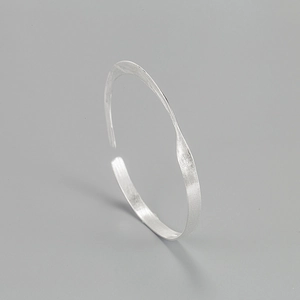 Minimalist 925 sterling silver open bracelet with a brushed texture and twisted design