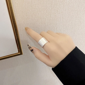 Close-up of wide S925 sterling silver ring featuring a brushed matte texture on finger