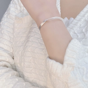 Detailed view of handmade 925 sterling silver bangle with brushed and polished texture