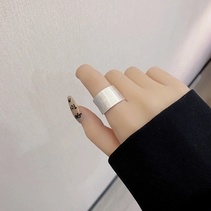 Macro shot of minimalist S925 sterling silver wide ring with a brushed matte texture finish