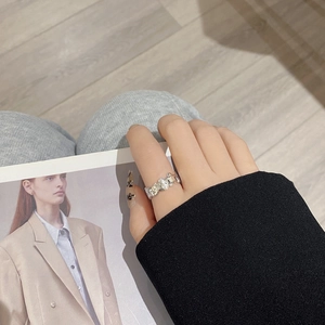 Detailed view of S925 silver ring featuring cartoon relief and a sparkling white stone