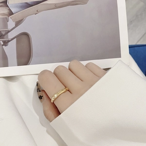 Minimalist irregular wave S925 sterling silver ring with golden finish on finger