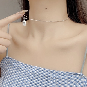 Close-up of S925 sterling silver ball chain necklace with Good Luck engraved pendant