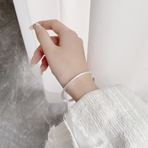 Macro shot of minimalist 925 sterling silver bangle with a brushed matte texture finish