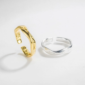 Close-up of S925 sterling silver Mobius rings with gold finish and engraved letters