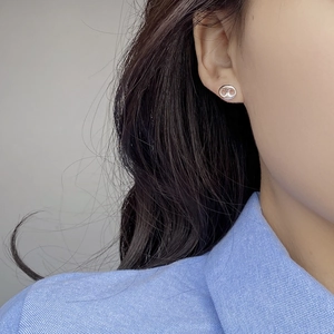 Elegant S925 sterling silver pig nose stud earrings worn on model for modern minimal look