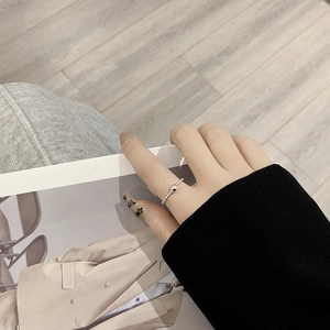 Minimalist S925 sterling silver beaded ring with polished metal ball on a fashion magazine