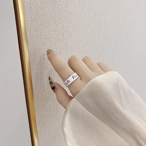 Close-up of minimalist S925 silver tulip ring with pink enamel detail on a model's finger