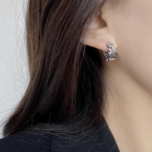 Retro 925 sterling silver hoop earrings with star relief pattern on model