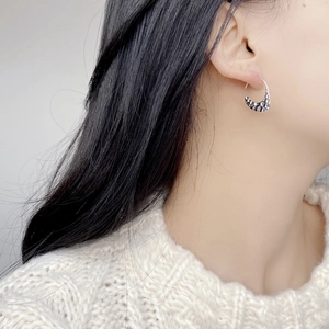 S925 sterling silver hammered crescent earrings worn by model with textured finish