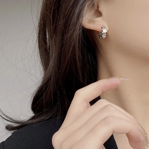 925 sterling silver hoop earrings with star relief pattern shown on ear for fashion