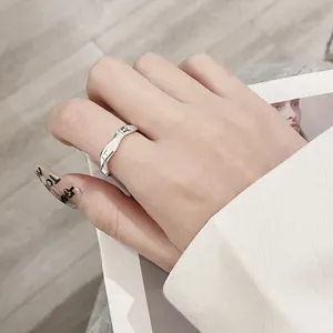 Minimalist S925 sterling silver Mobius twist ring with engraved lettering on model hand