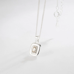 Elegant 925 sterling silver necklace featuring a nested rectangular zirconia pendant