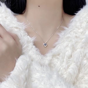 Elegant S925 sterling silver heart necklace with MOM engraving worn on the collarbone