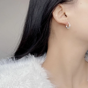 Close-up of S925 sterling silver hoop earring with multi-layer stacked texture on model