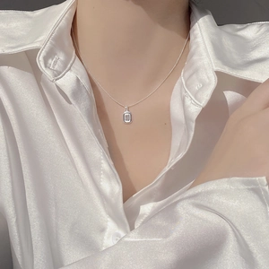 Elegant 925 sterling silver necklace with a geometric rectangular gemstone pendant on a model