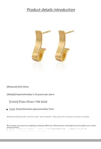 Macro detail of J-shaped S925 sterling silver earrings with brushed matte gold texture