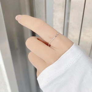 Detailed close-up of a minimalist S925 sterling silver adjustable chain ring on finger